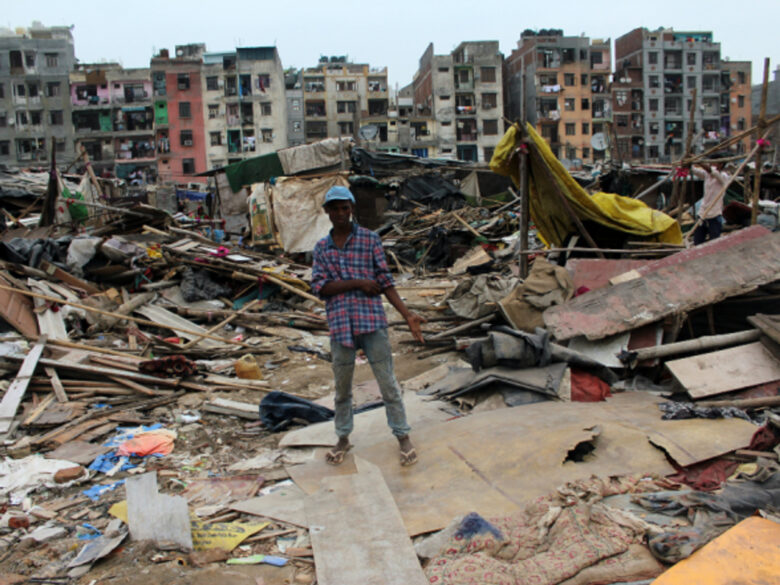 A boy at the site of demolished slum dwellings At Okhla In New Delhi