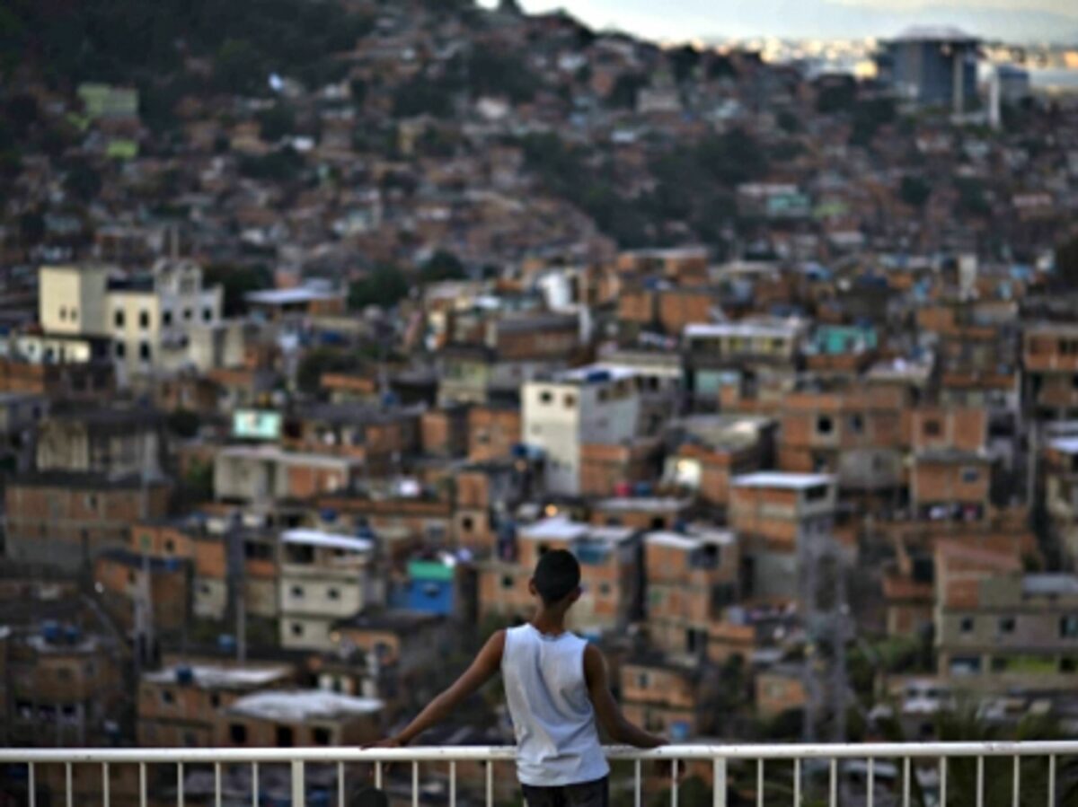 A boy looking at a Rio favela