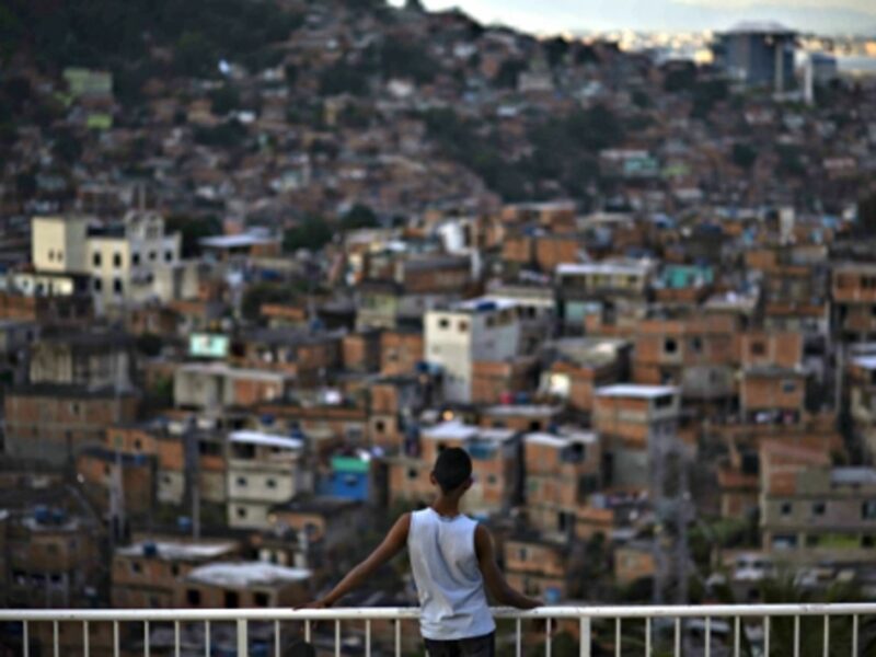 A boy looking at a Rio favela