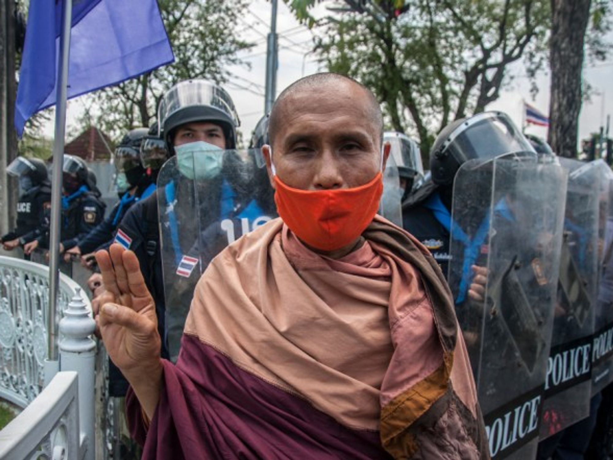 A Buddhist monk makes the three finger salute during pro-democracy protests in Bangkok, Thailand.