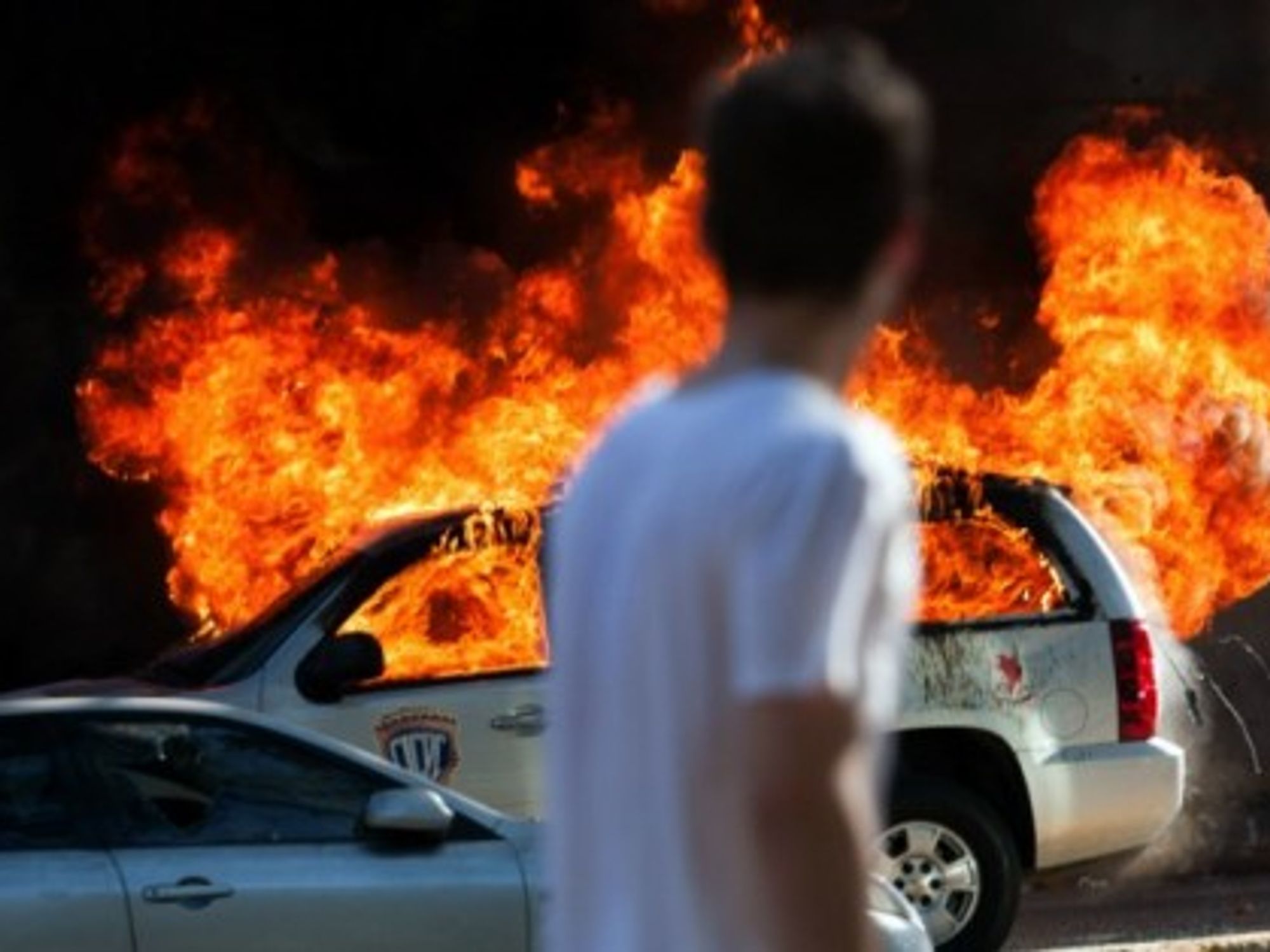A car burns during clashes between students and police during anti-government protests in Venezuela.