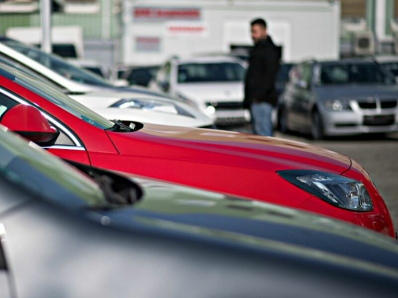 A car salesman looking over used diesel cars in Stuttgart, Germany