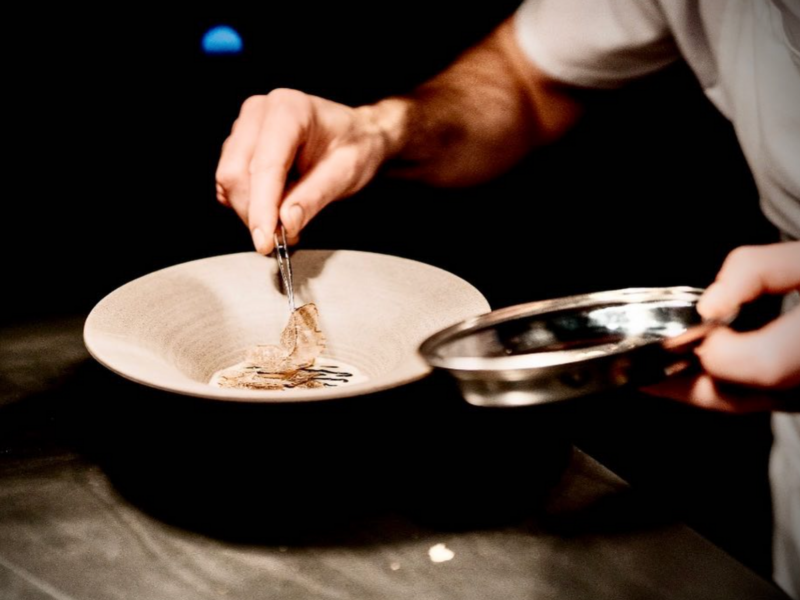 A chef plates a dish at Bottiglieria 1881.