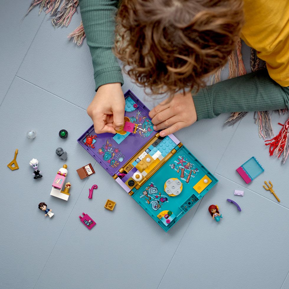 A child playing with the Little Mermaid Lego set released to accompany the new Disney movie.