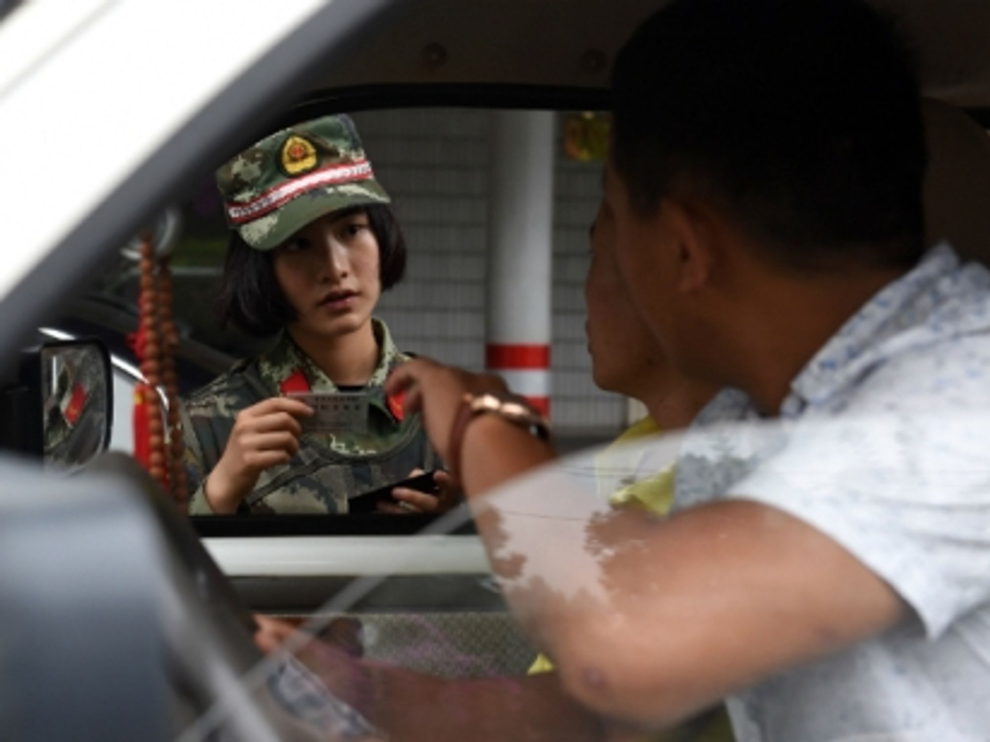A Chinese anti-drug soldier inspects a car in the southwest Yunnan province, on June 24, 2015