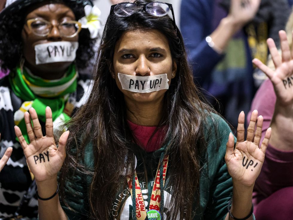 A climate activist takes part in a protest during the COP29 closing ceremony in Baku, Azerbaijan.