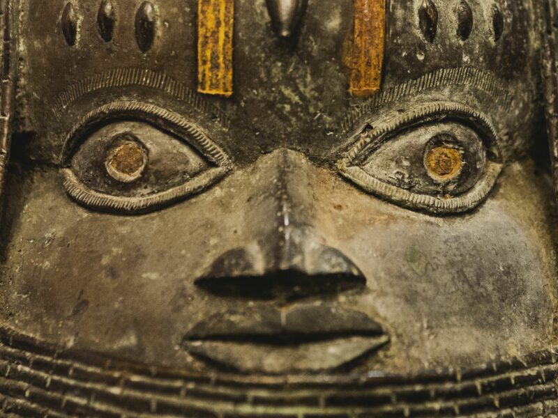 A close up of the face of a Benin bronze