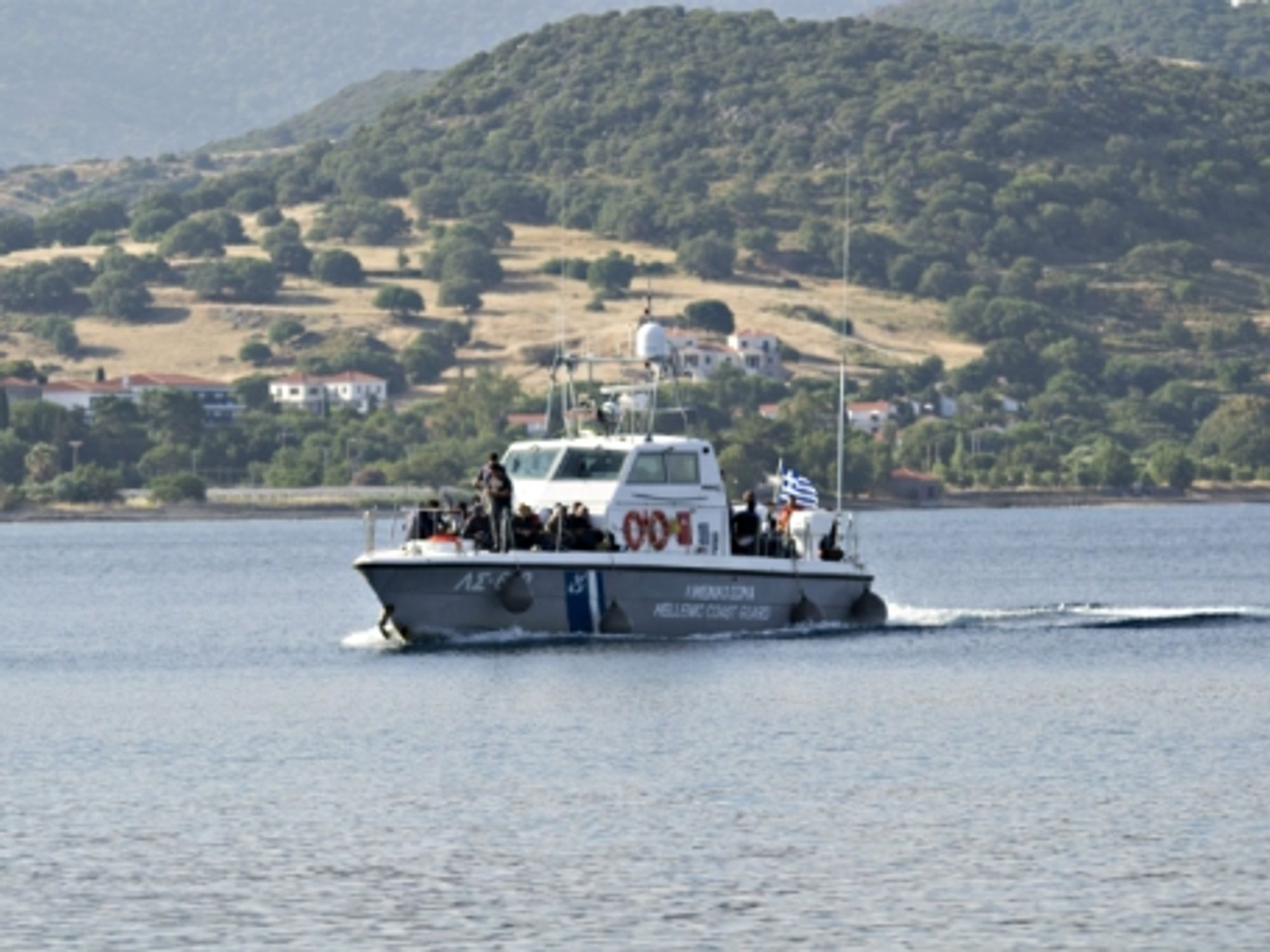 A coast guard boat carrying rescued refugees approaching the Greek island of Lesbos