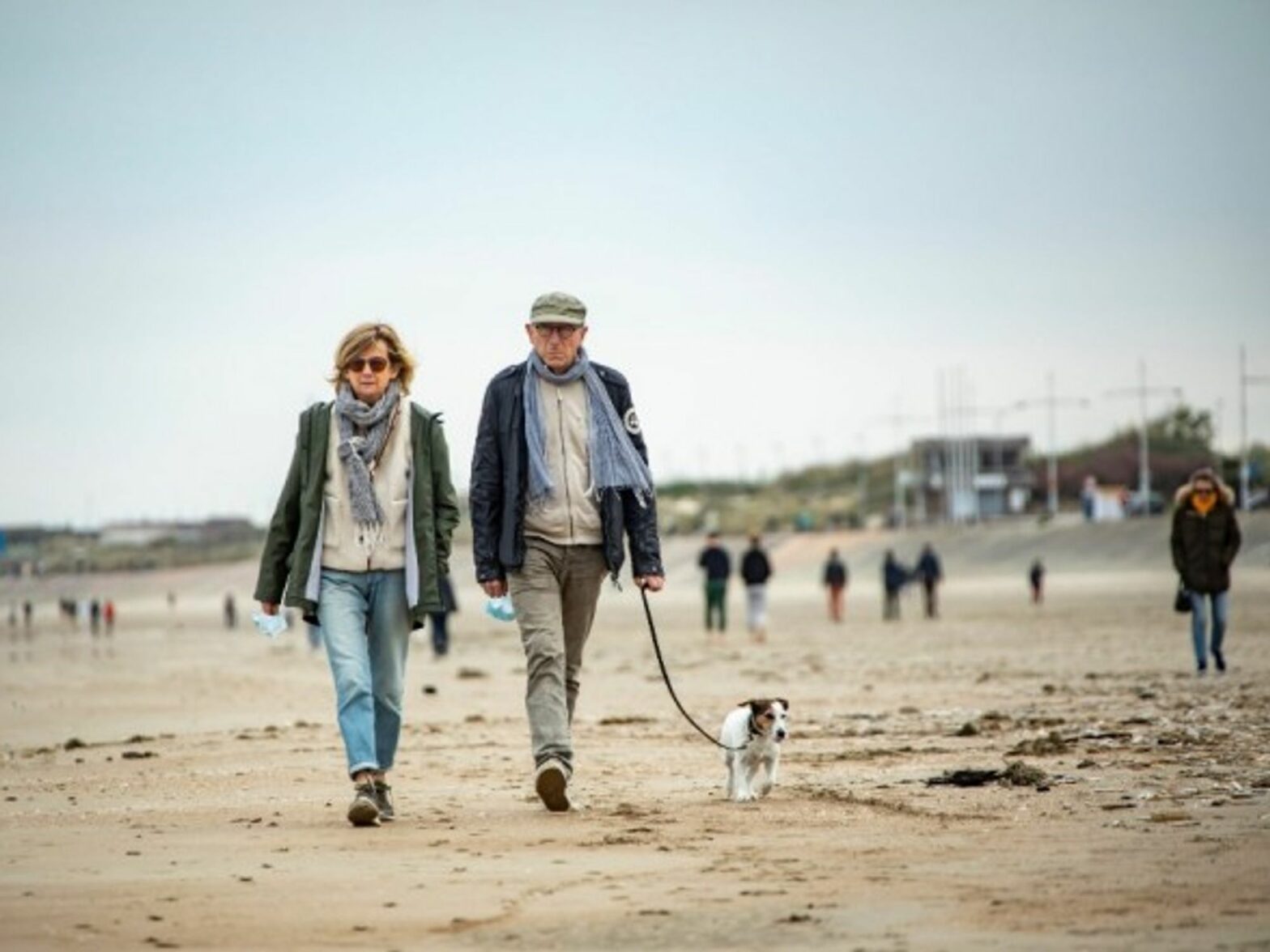 A couple walks on a beach in Dunkirk, France.