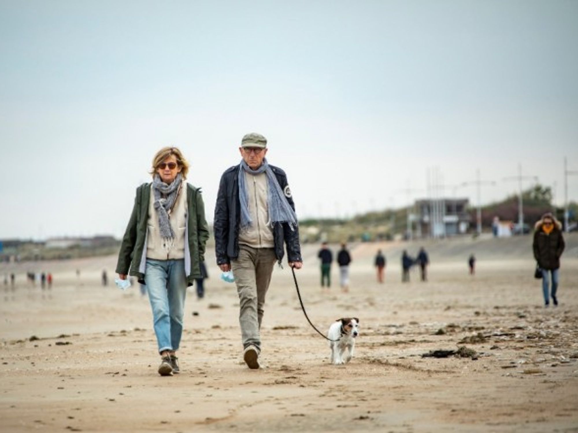 A couple walks on a beach in Dunkirk, France.