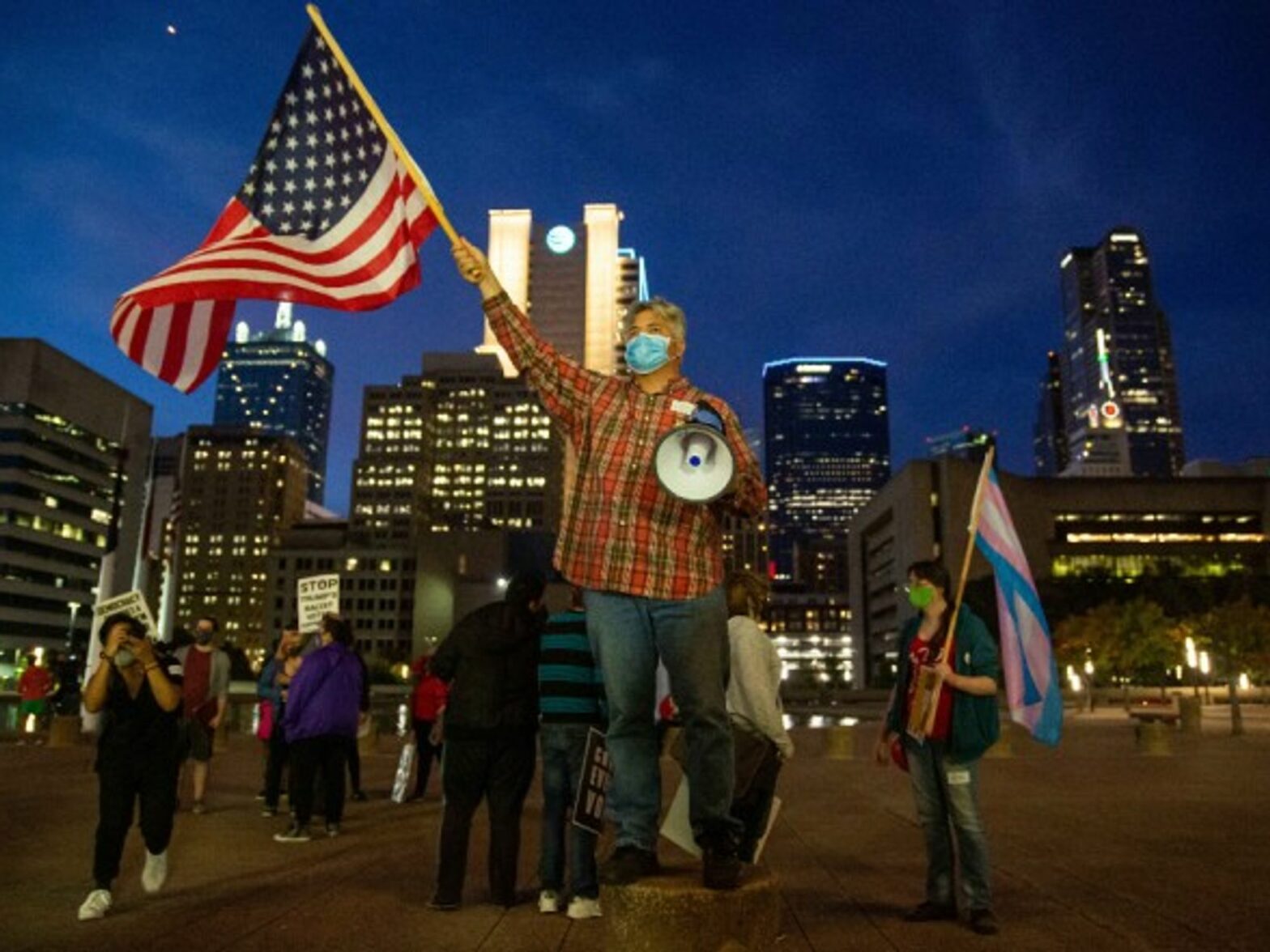 A Dallas voter waving an American Flag during a rally
