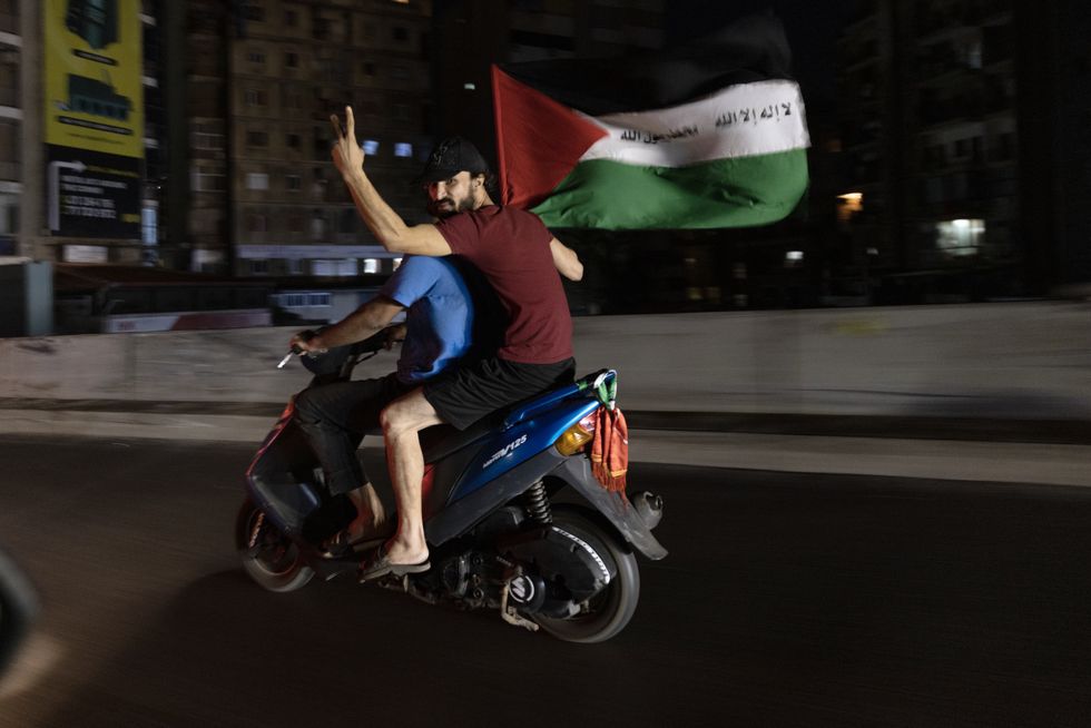 A demonstrator drives near the U.S. Embassy at Awkar, in Lebanon toward a protest against the Israeli strike at the Al-Ahli Baptist Hospital, that killed around 500 people in Gaza.