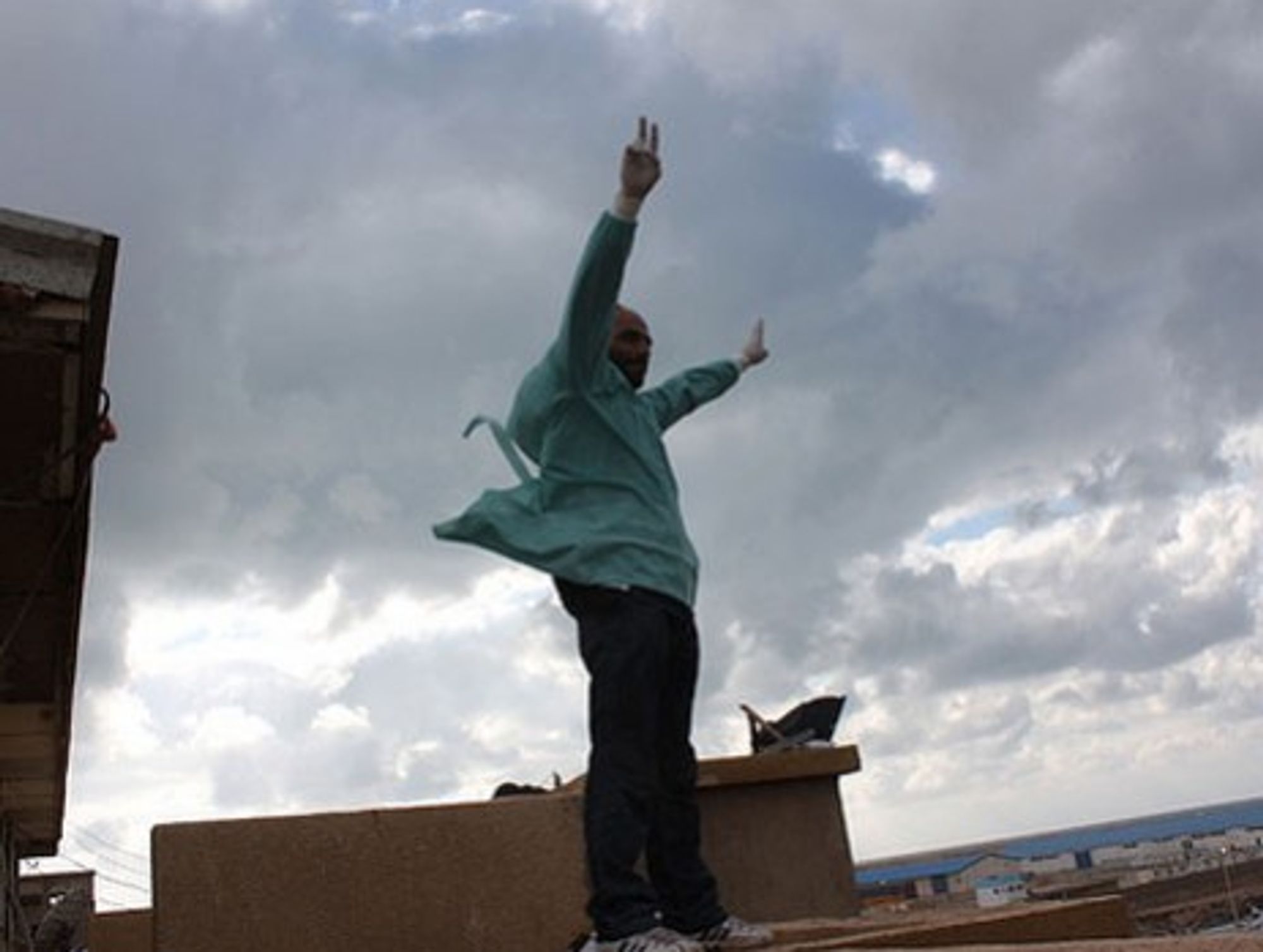 A doctor last month waves the Victory sign atop the Benghazi courthouse