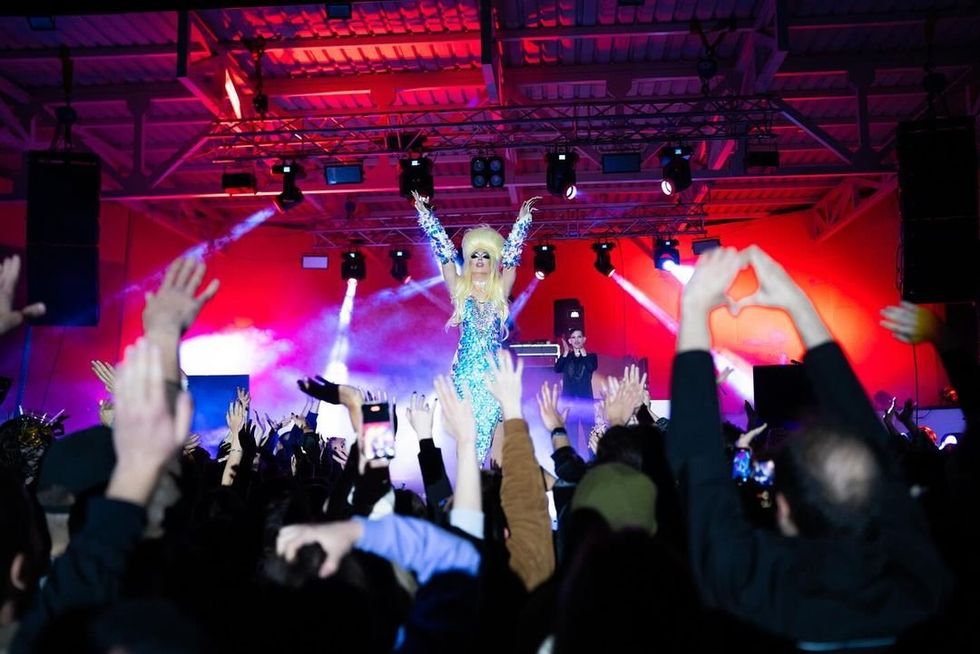 A drag queen performing in front of a large audience.