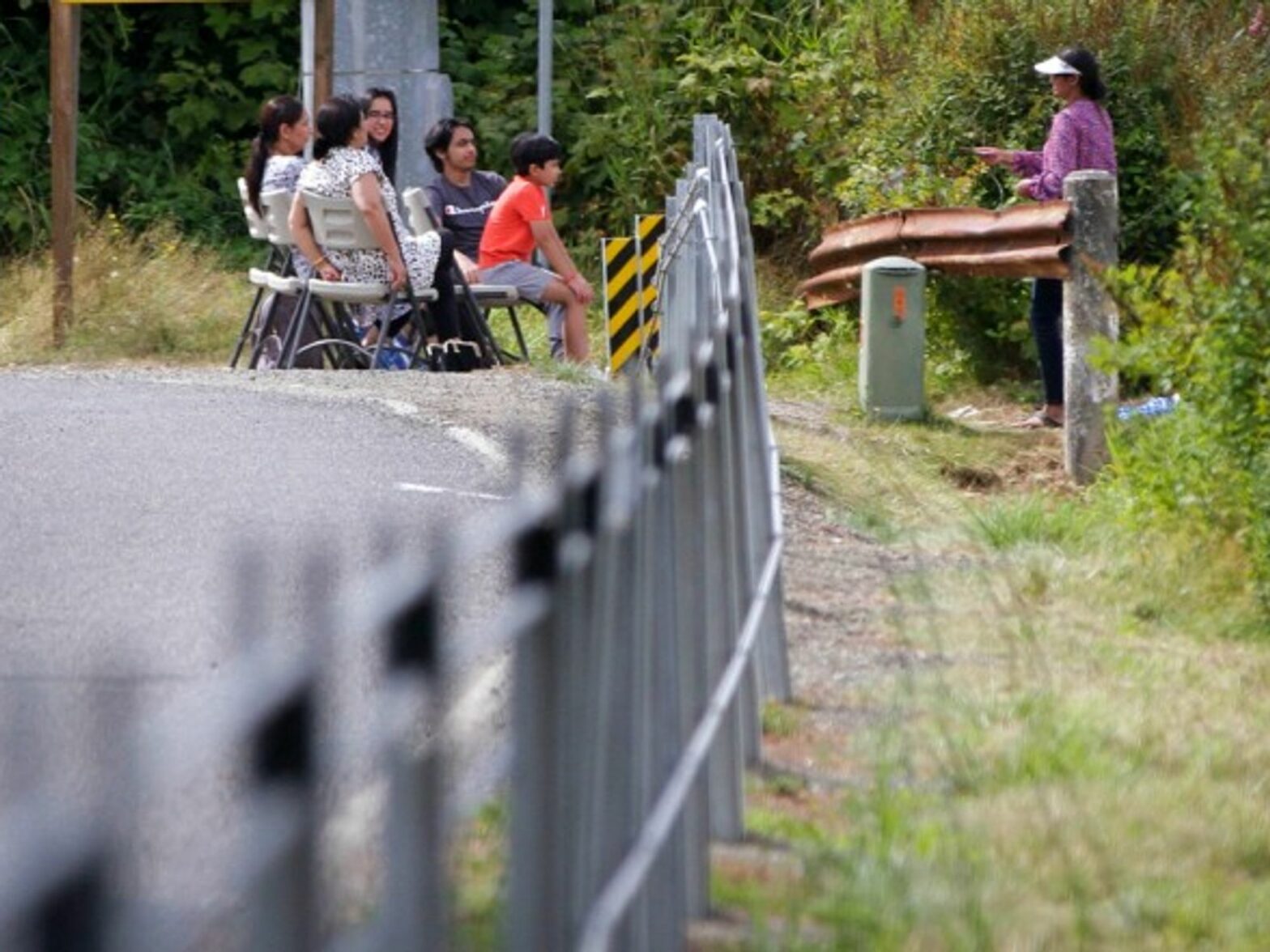 A family gathering near a cable barrier along the border between Canada and the United States