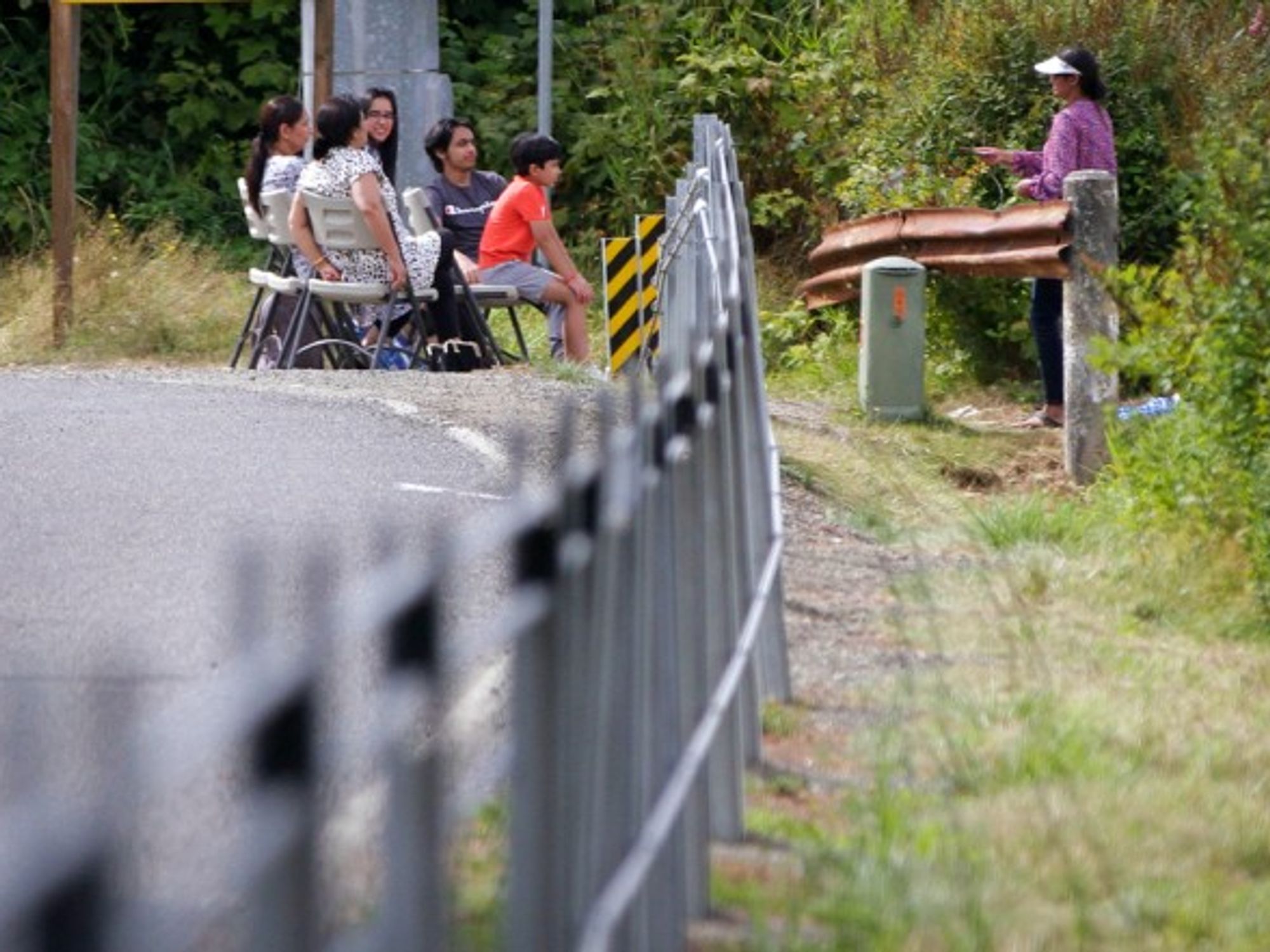 A family gathering near a cable barrier along the border between Canada and the United States