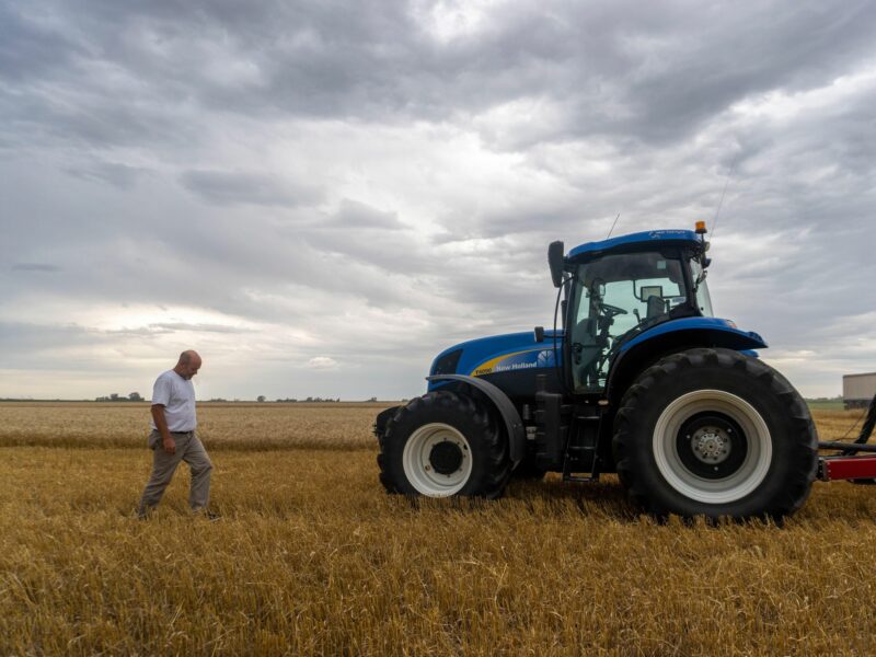 A farmer and his tractor in a wheatfield in Argentina.
