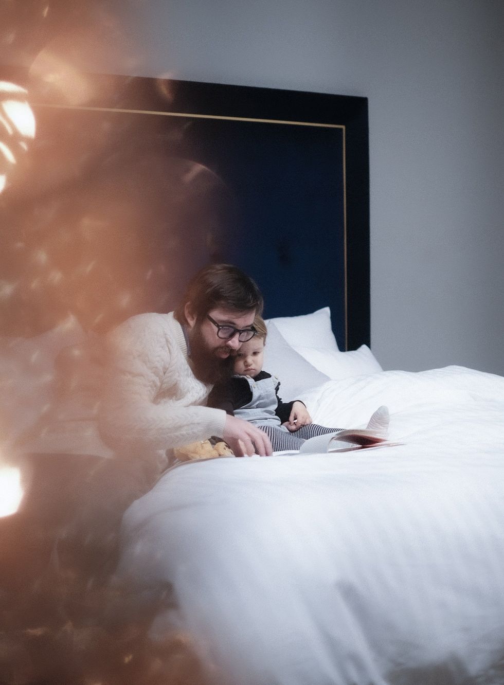 A father reading a story to his child.​