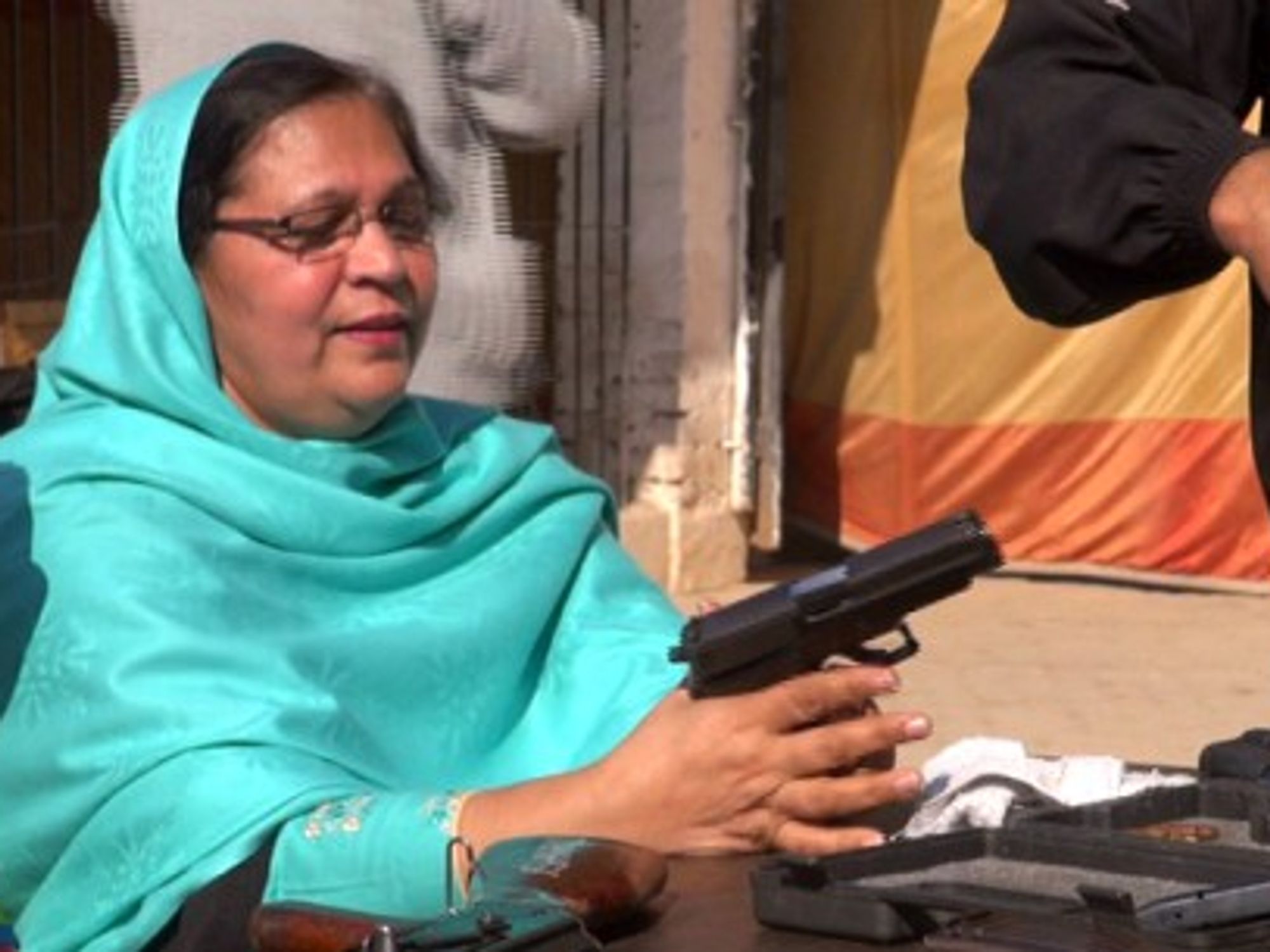 A female teacher trying a gun.