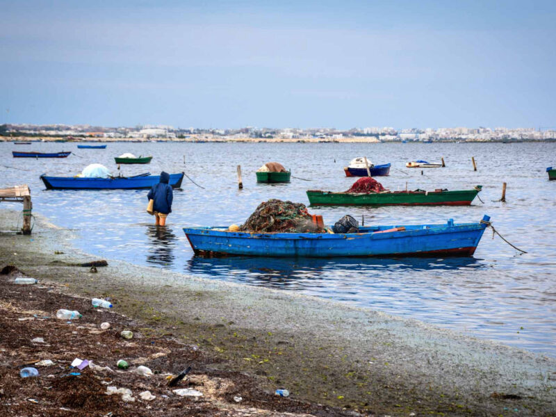 A fisherman walks to his boat in the bay of Ksibet El-Mediouni.