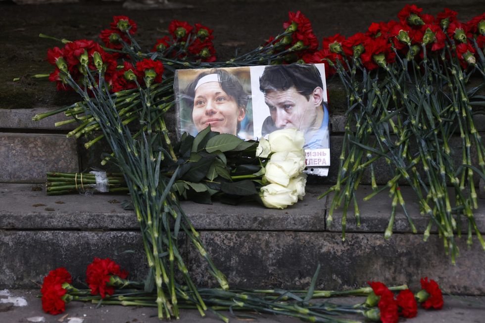 A flower laying ceremony in memory of Anastasia Baburova and Stanislav Markelov.