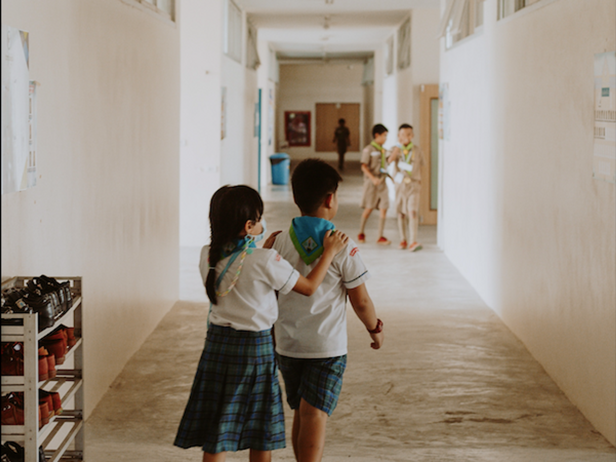 a girl and boy in school uniforms