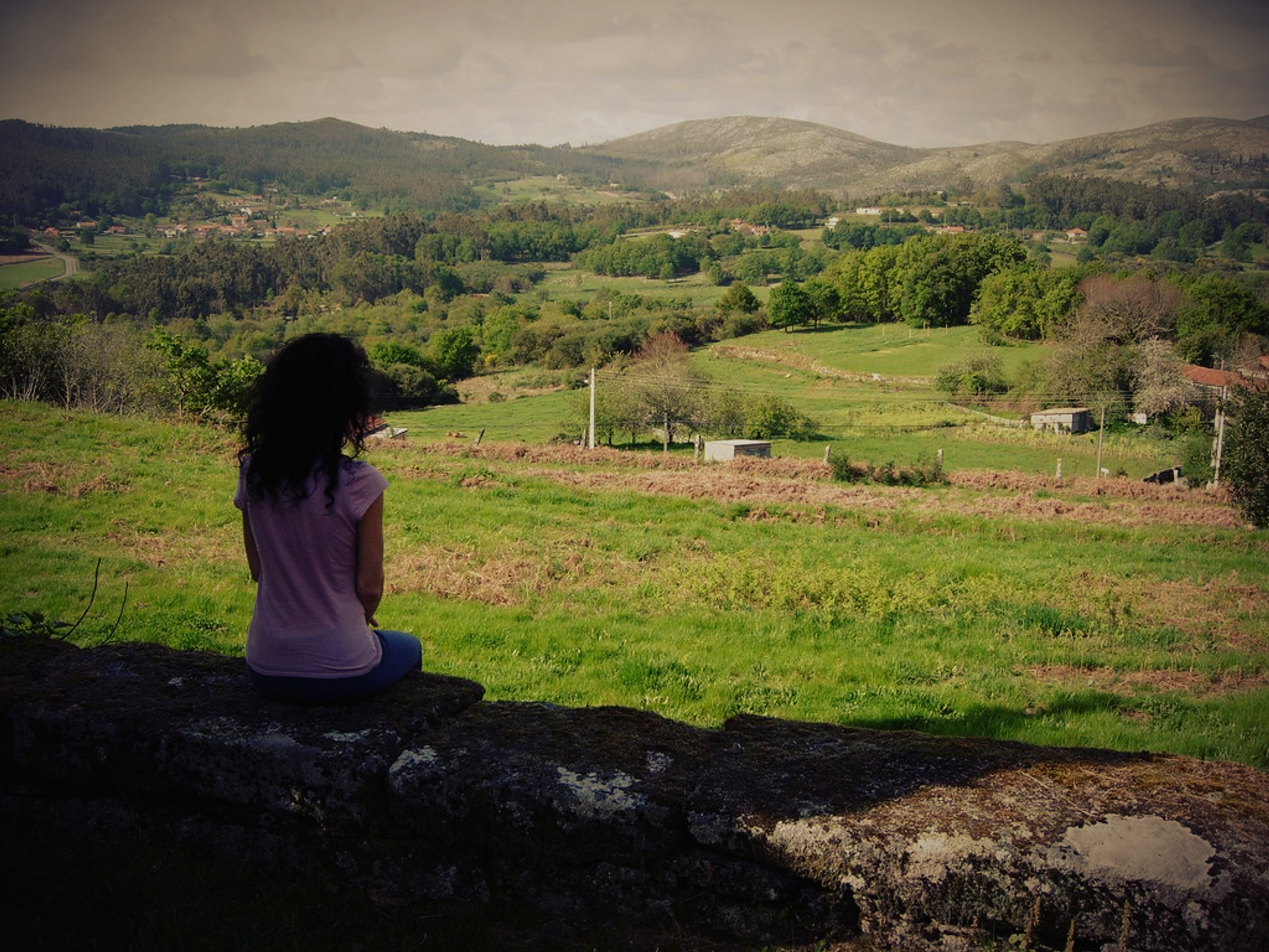 a girl looks across a valley