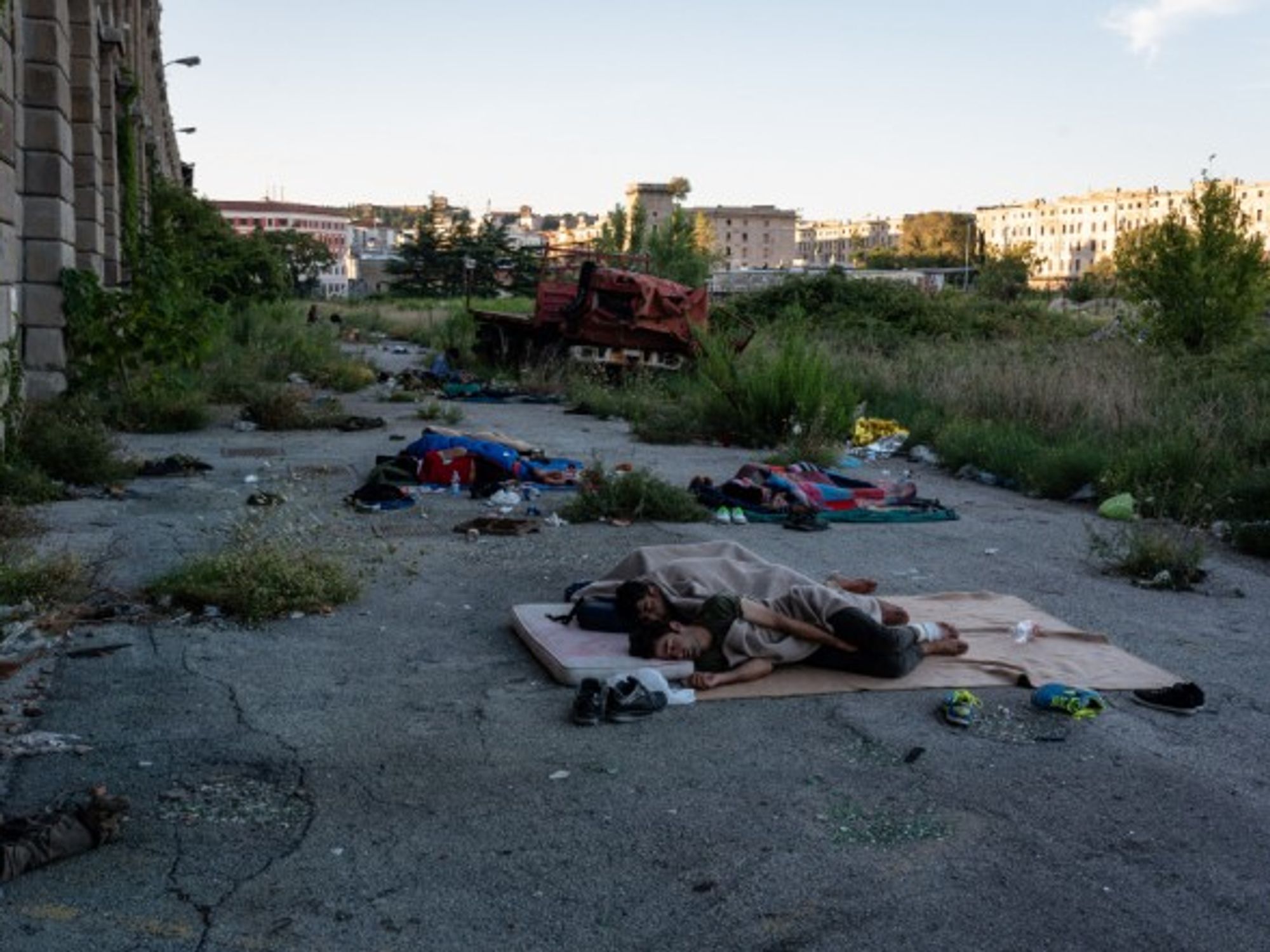 A group of refugees sleeping outside of Silo, an abandonned car park. In Trieste, Italy