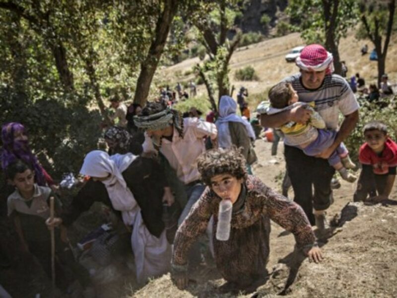 A group of Yazidis Kurds, mostly women and children, arrive at a village in Sirnak, Turkey.