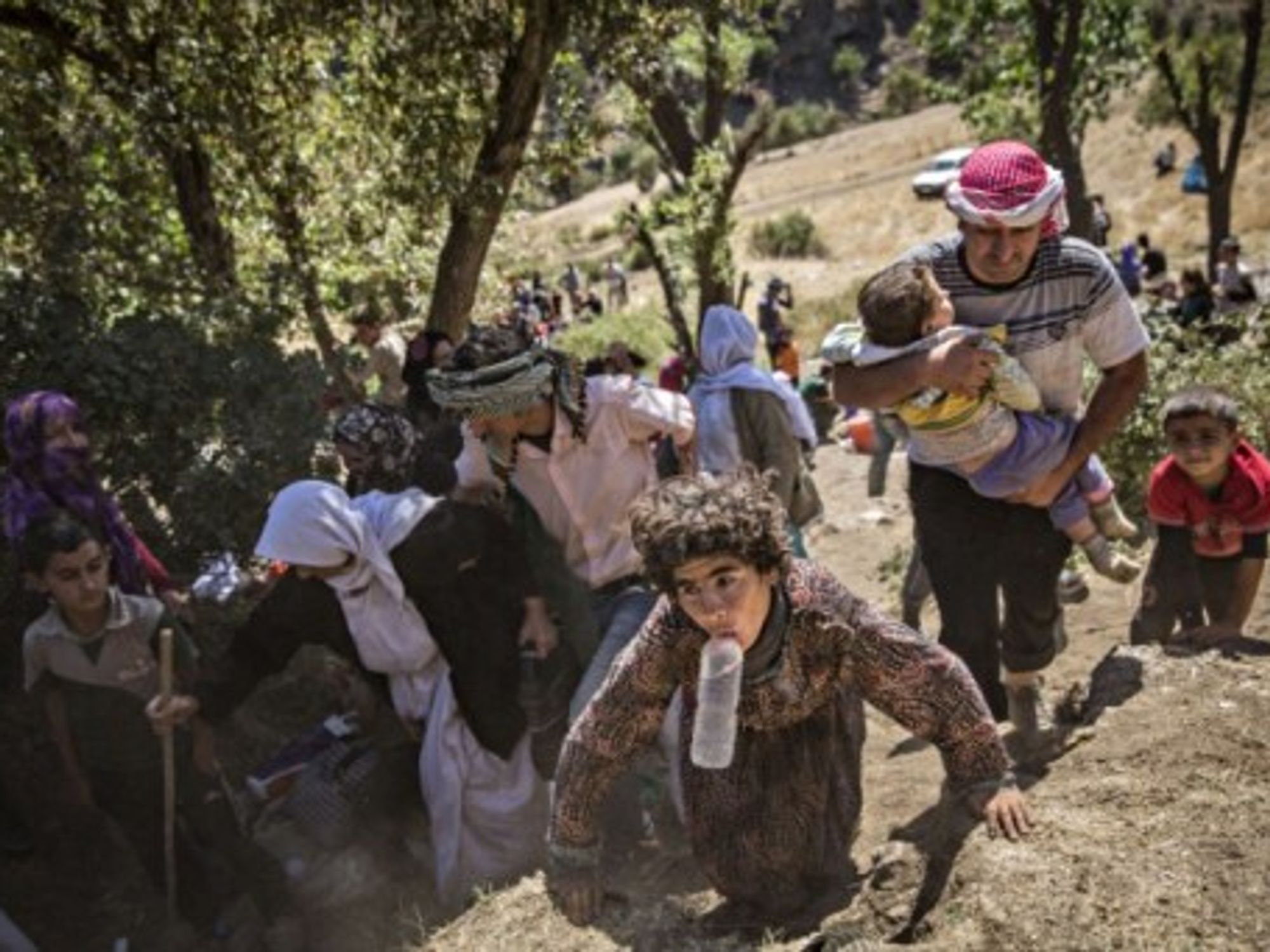 A group of Yazidis Kurds, mostly women and children, arrive at a village in Sirnak, Turkey.