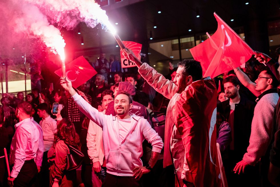 A group of young citizens burn flare sticks during the election victory celebration.