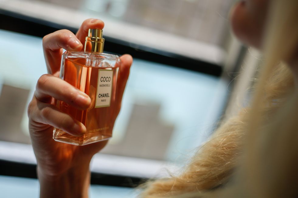 A hand sprays a bottle of ''Coco Mademoiselle'' perfume by Chanel