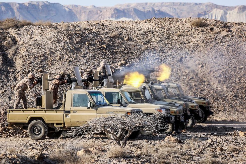 A handout photo made available by Iran's Revolutionary Guard Corps (IRGC) official website on 23 December 2021 shows the Islamic Revolutionary Guard Corps (IRGC) taking part in military exercises in three provinces around the Bushehr nuclear power plant, in southern Iran.