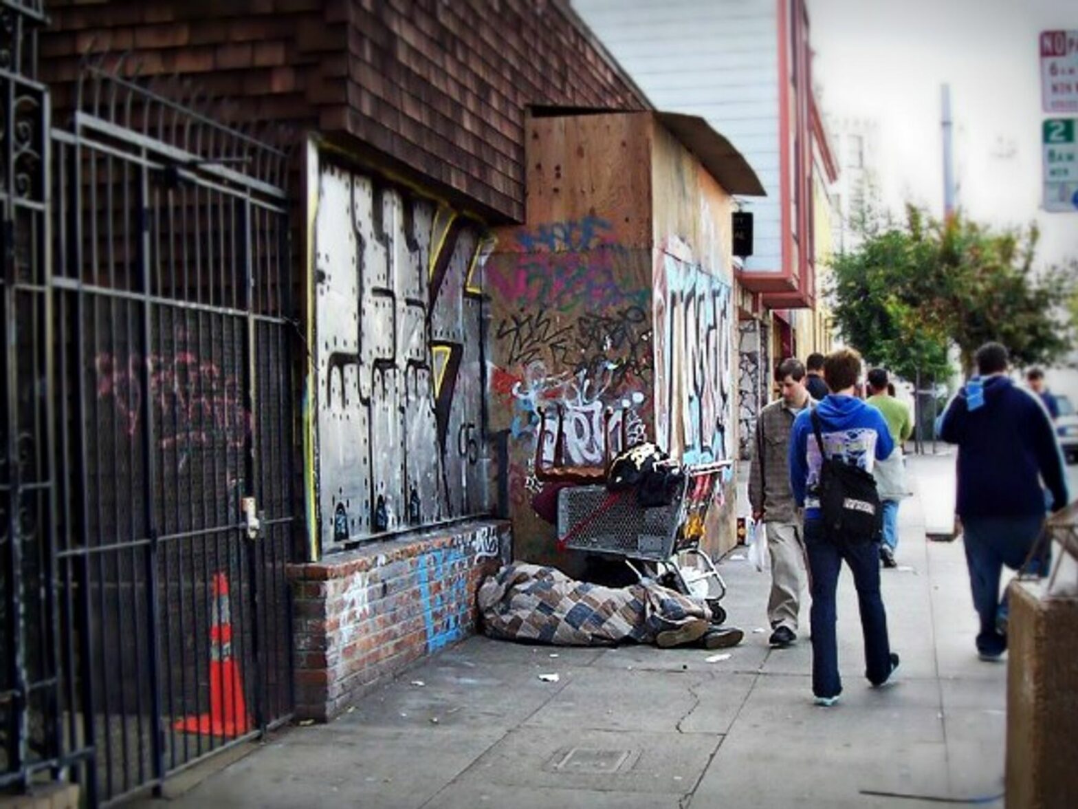 A homeless person resting on Church Street in San Francisco, California