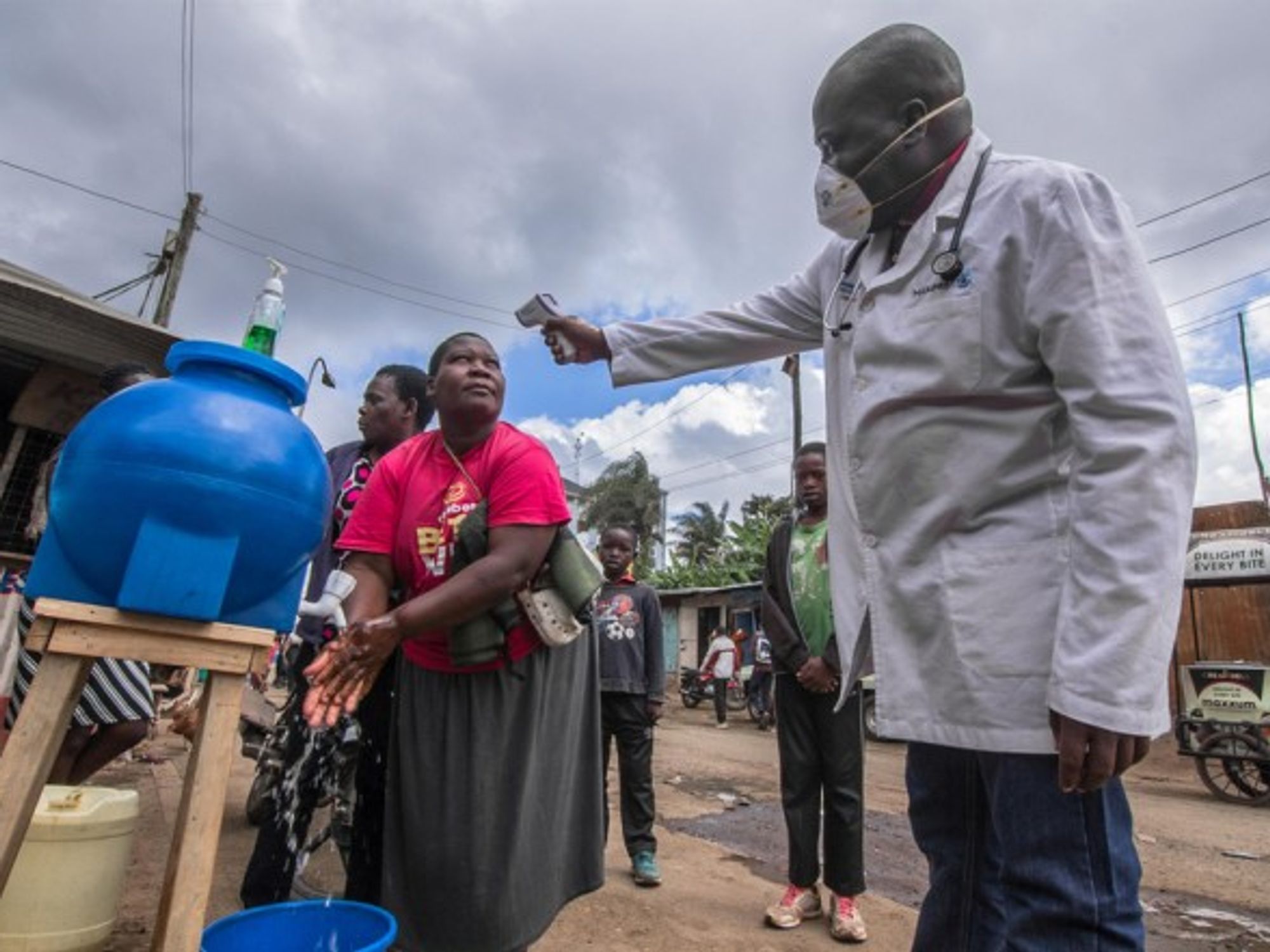 A local doctor perfoming a temperature check up for the locals in Kenya