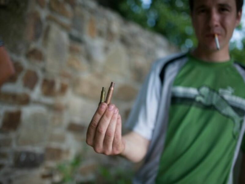 A local resident shows a shell case on the outskirt of Lysychansk in Donetsk region.