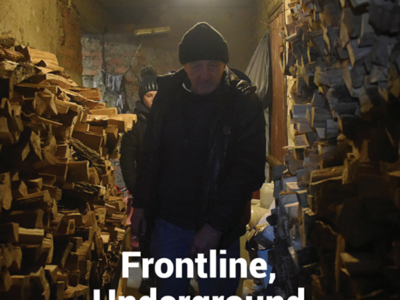 A man and a women in a basement surrounded by a stockpile of wood