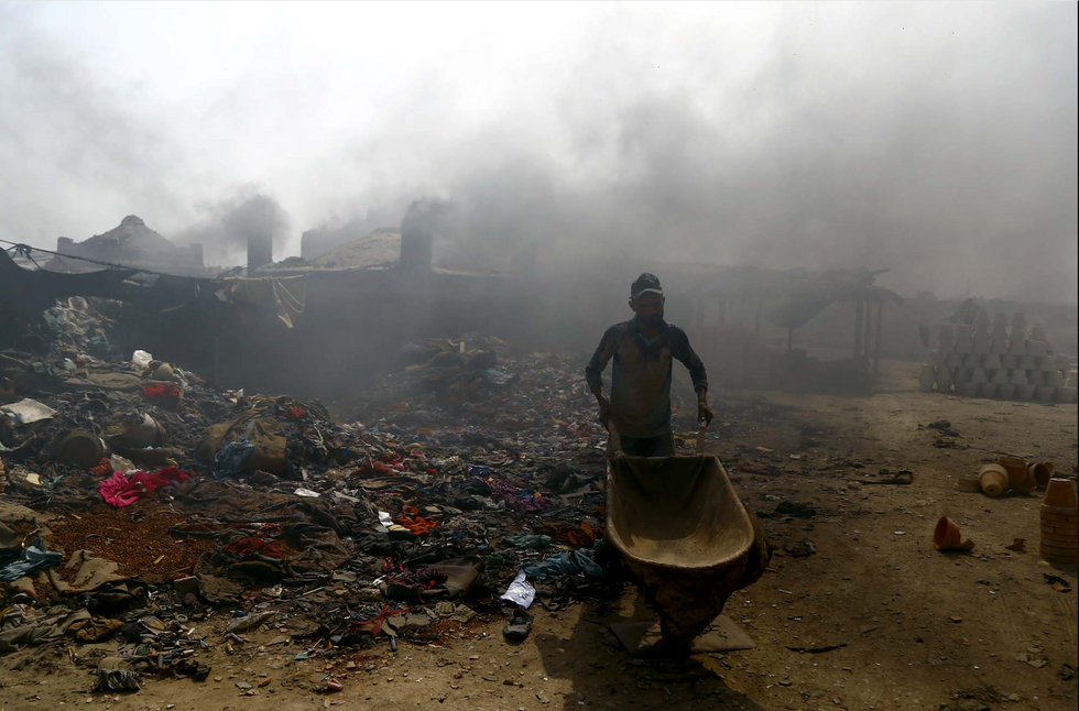 A man at moving trash to be burned