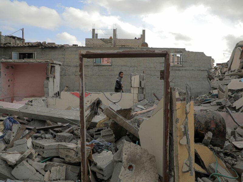 A man checks rubble of destroyed buildings after an Israeli airstrike in the southern Gaza Strip city of Rafah, April 21, 2024.​