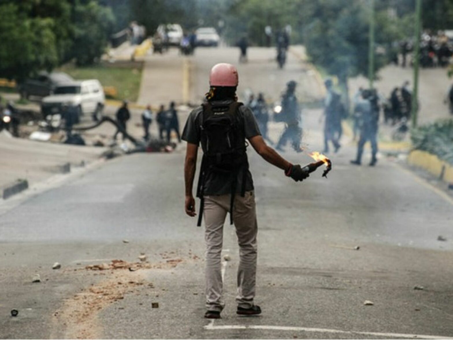 A man holding a molotov cocktail during clashes in Valencia, Venezuela