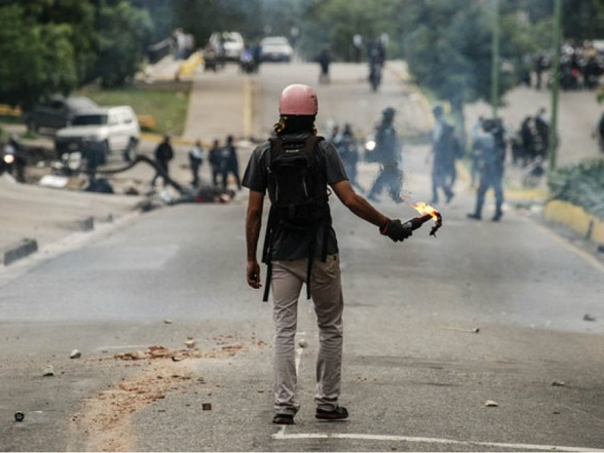 A man holding a molotov cocktail during clashes in Valencia, Venezuela