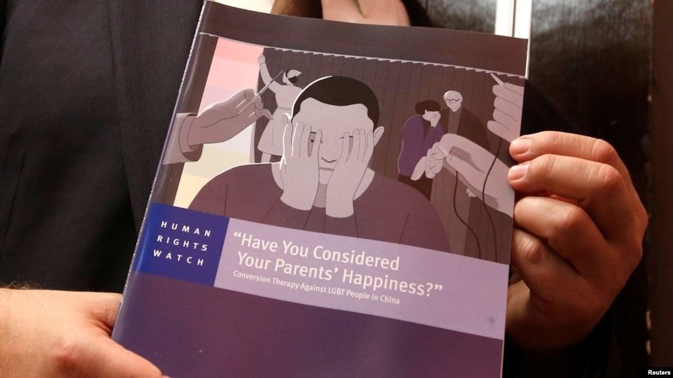 A man holding a report.
