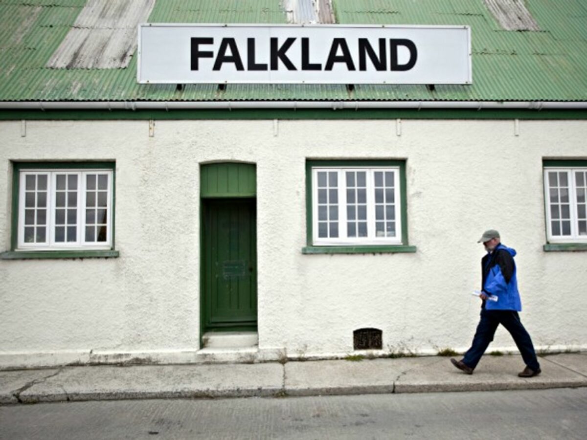 A man passes by a store in the Falklands