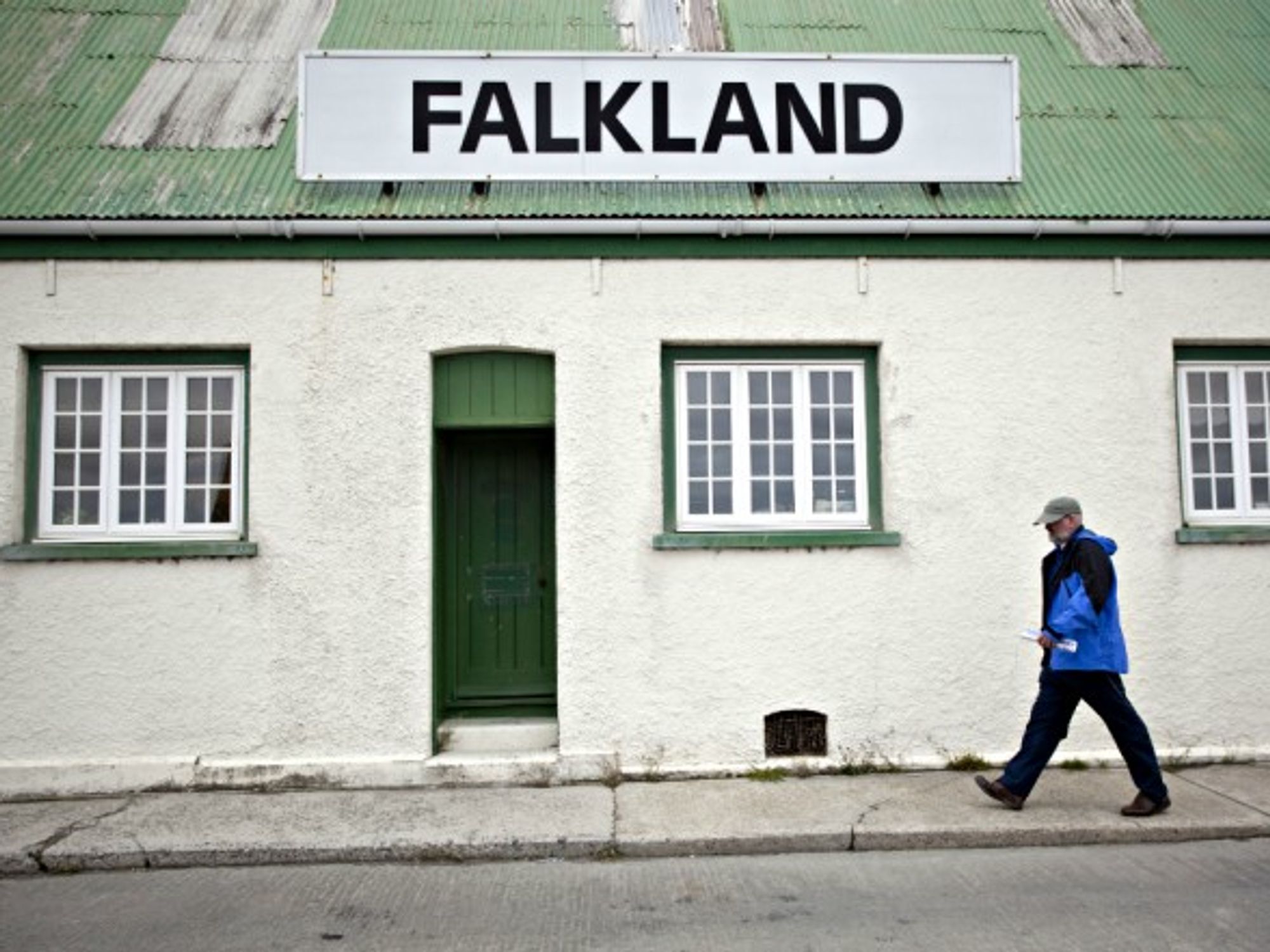 A man passes by a store in the Falklands