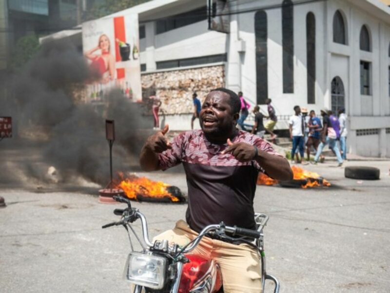 A man protests in the streets of Port-au-Prince after the assassination of President Moise
