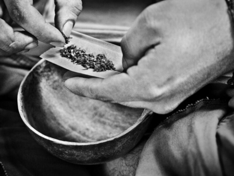 A man rolls a marijuana joint in Palenque, Mexico