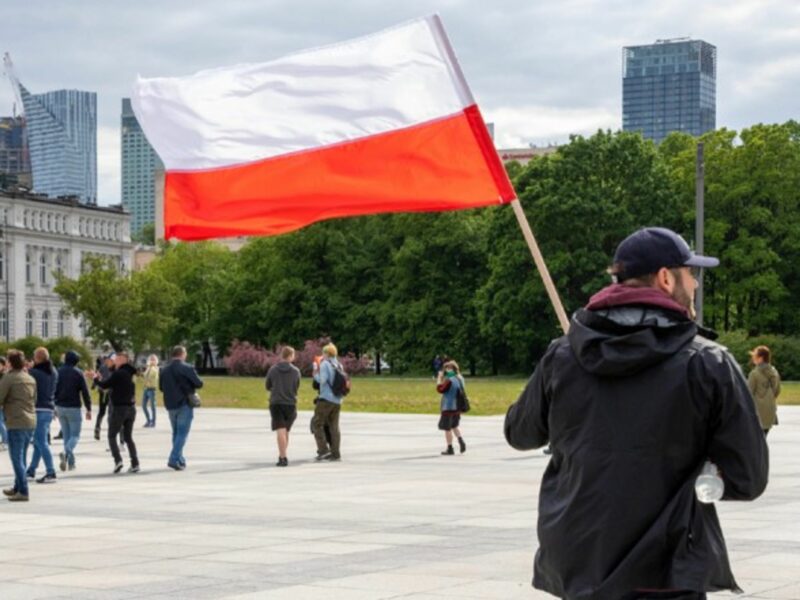 A man stands with the Polish flag during a National Entrepreneur strike in Warsaw, Poland.
