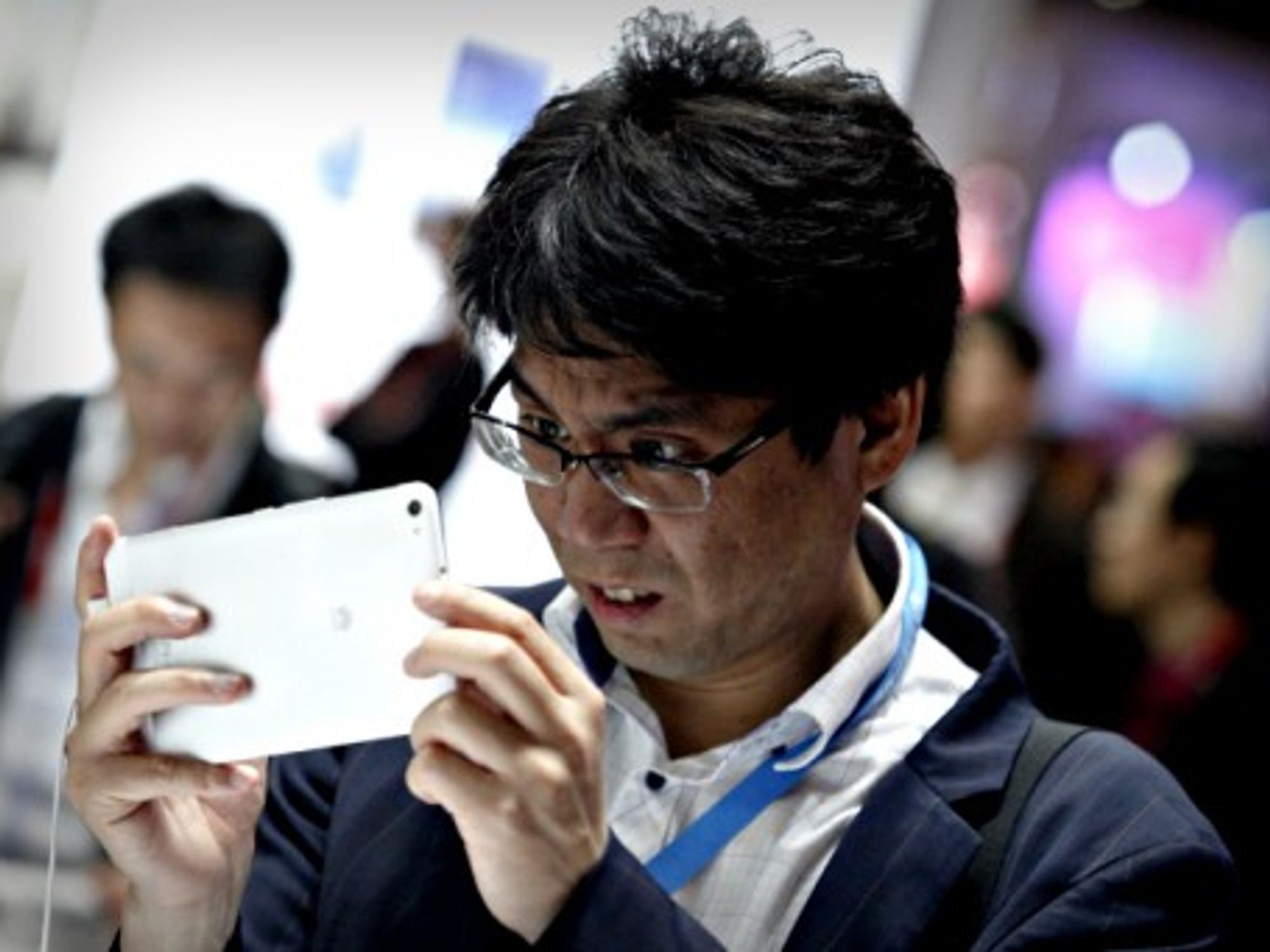 A man takes a picture with a Huawei device in February