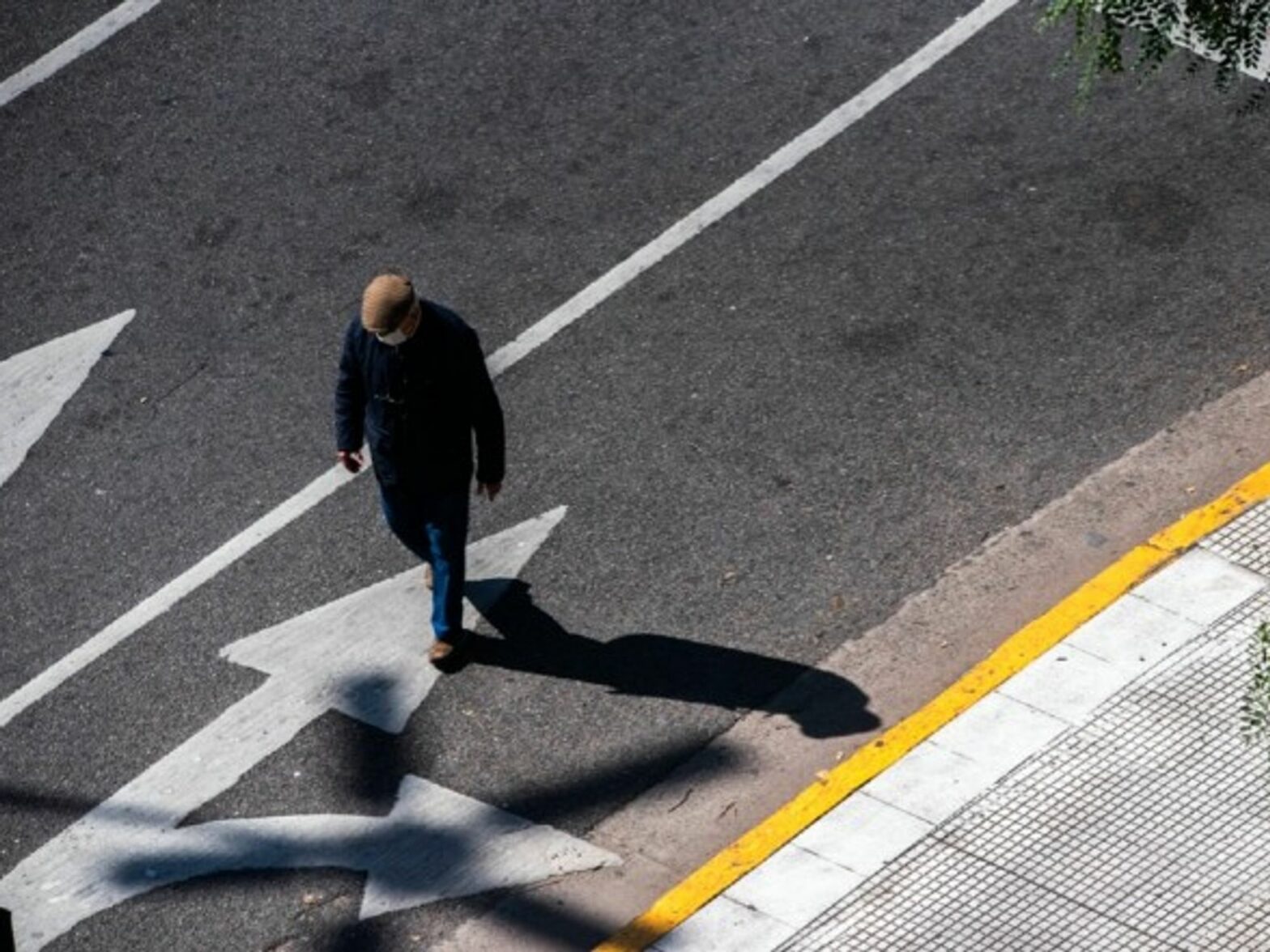 A man walked down the street wearing a mask in Buenos Aires.