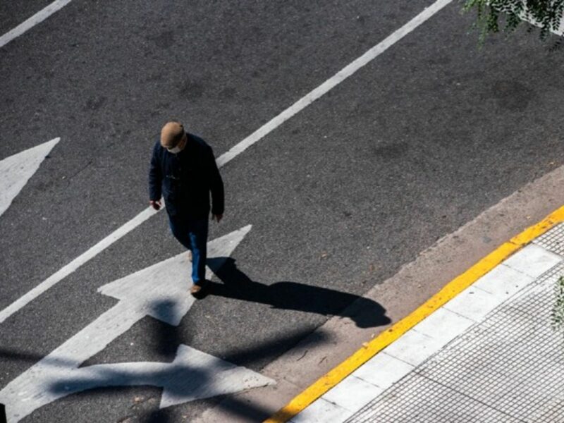 A man walked down the street wearing a mask in Buenos Aires.